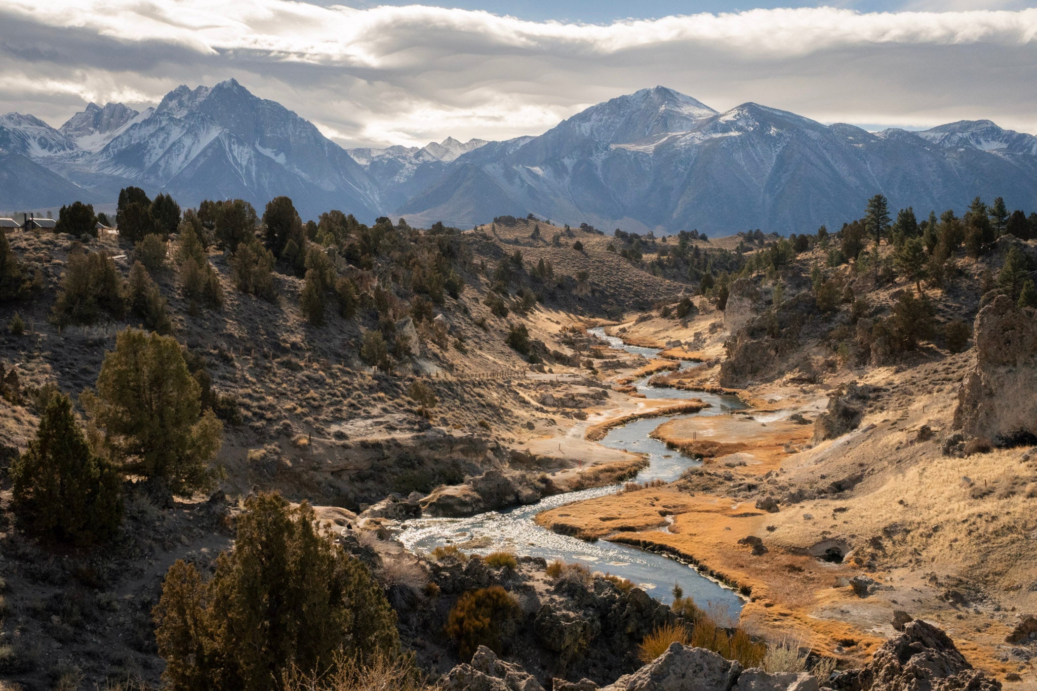 Scenic view of a river flowing through a valley with mountains in the background