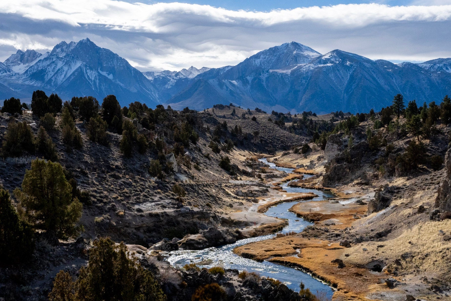 Scenic view of a river flowing through a valley with mountains in the background